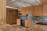 Discover this stunning kitchen featuring custom wood cabinetry and elegant marble countertops.