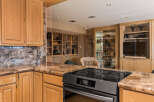 Experience luxury in this stunning kitchen featuring elegant marble countertops and custom wood cabinetry.