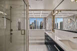 Experience luxury in this stunning bathroom featuring a freestanding soaking tub with breathtaking city views.