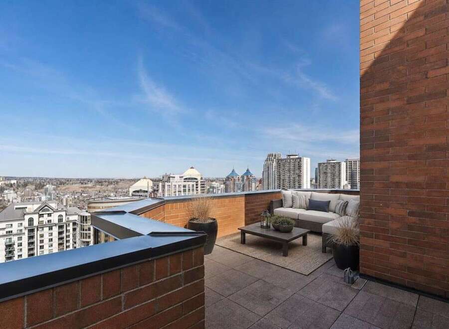 Experience breathtaking city views from this expansive rooftop terrace, perfect for entertaining or relaxing.