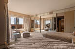 Experience luxurious city living in this spacious master suite, featuring two plush beds and a private balcony with stunning city views.