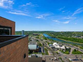 Experience breathtaking panoramic views from this stunning property, overlooking the serene river and vibrant cityscape.