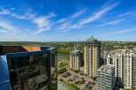 Experience breathtaking panoramic views from this stunning high-rise property, offering a unique perspective of the city skyline and distant mountains.