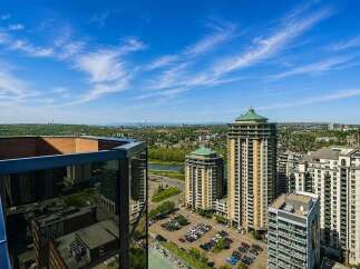 Experience breathtaking panoramic views from this stunning high-rise property, offering a unique perspective of the city skyline and distant mountains.