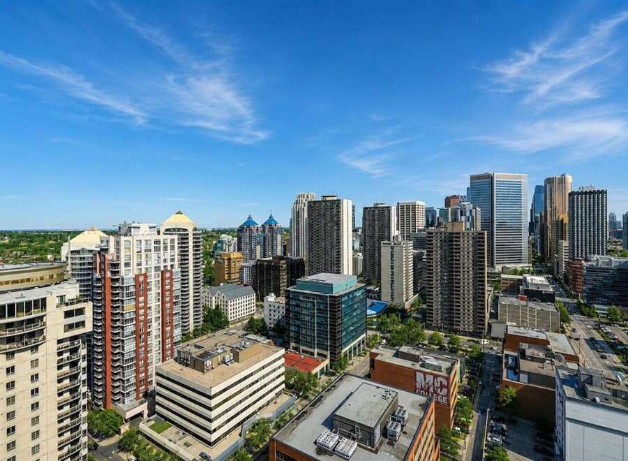 Experience urban living at its finest with this stunning cityscape view, showcasing a vibrant collection of modern high-rise buildings.