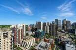 Experience urban living at its finest with this stunning cityscape view, showcasing a vibrant collection of modern high-rise buildings.
