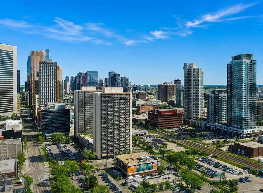 Experience urban living at its finest in this vibrant cityscape, featuring a collection of modern high-rise buildings.