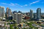 Experience urban living at its finest in this vibrant cityscape, featuring a collection of modern high-rise buildings.