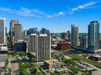 Experience urban living at its finest in this vibrant cityscape, featuring a collection of modern high-rise buildings.