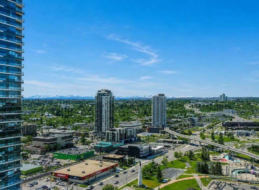 Experience breathtaking mountain views from this stunning urban high-rise, offering a prime location amidst a vibrant cityscape.