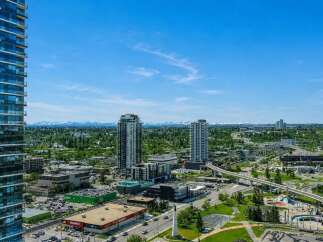 Experience breathtaking mountain views from this stunning urban high-rise, offering a prime location amidst a vibrant cityscape.