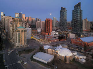 Experience urban living at its finest in this stunning cityscape featuring modern high-rise apartments and commercial buildings.