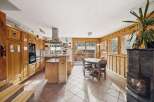 This charming kitchen boasts warm wooden cabinetry and a spacious island, perfect for meal preparation and casual dining.