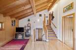 Experience rustic charm in this inviting home featuring a stunning wood-paneled ceiling and walls, creating a warm and cozy atmosphere.