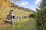 Experience the charm of alpine living with this stunning property, featuring a rustic stone barbecue area perfect for outdoor entertaining.