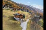 Experience alpine living in this charming wooden chalet nestled on a picturesque mountainside.