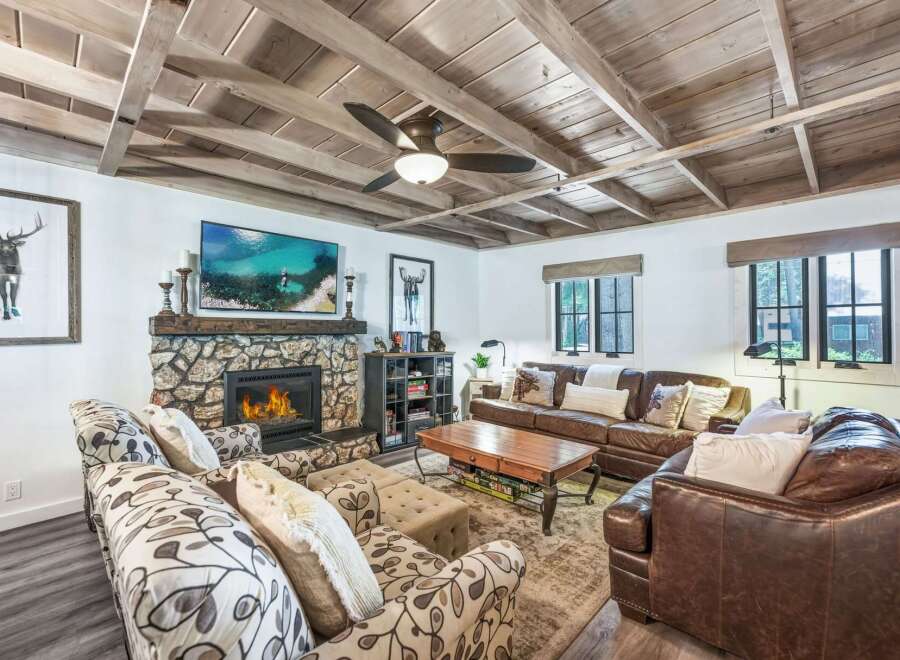 Experience rustic charm in this inviting living room, featuring a stunning stone fireplace as the centerpiece.