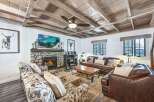 Experience rustic charm in this inviting living room, featuring a stunning stone fireplace as the centerpiece.