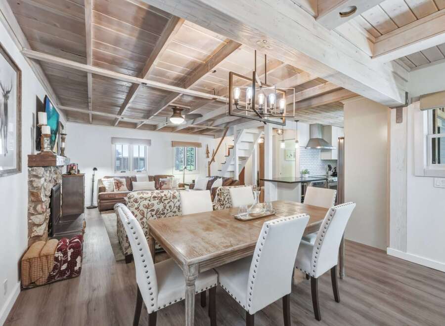 Experience rustic charm and modern comfort in this inviting living and dining space.