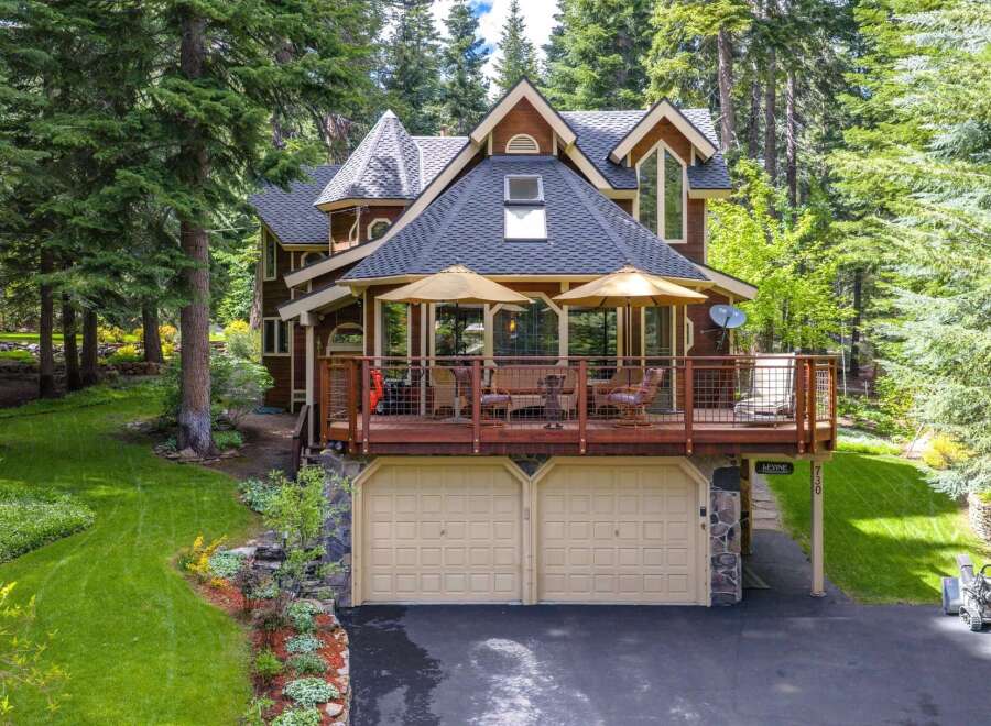 Nestled amidst towering trees, this charming mountain home offers a serene retreat.