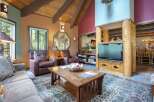 Experience rustic charm in this inviting living room, featuring plush leather armchairs and a comfortable sofa perfect for relaxation.