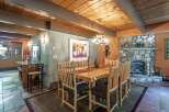 Experience rustic charm in this inviting dining room, featuring a solid wood table and chairs perfect for family gatherings.