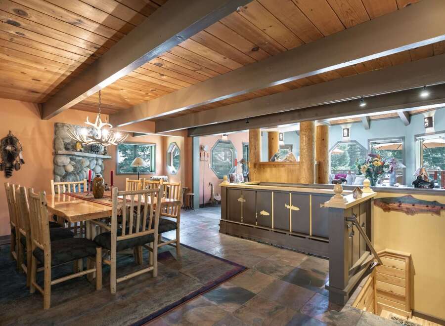 Experience rustic charm in this inviting dining area, featuring a solid wood table and chairs perfect for gathering.