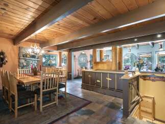 Experience rustic charm in this inviting dining area, featuring a solid wood table and chairs perfect for gathering.