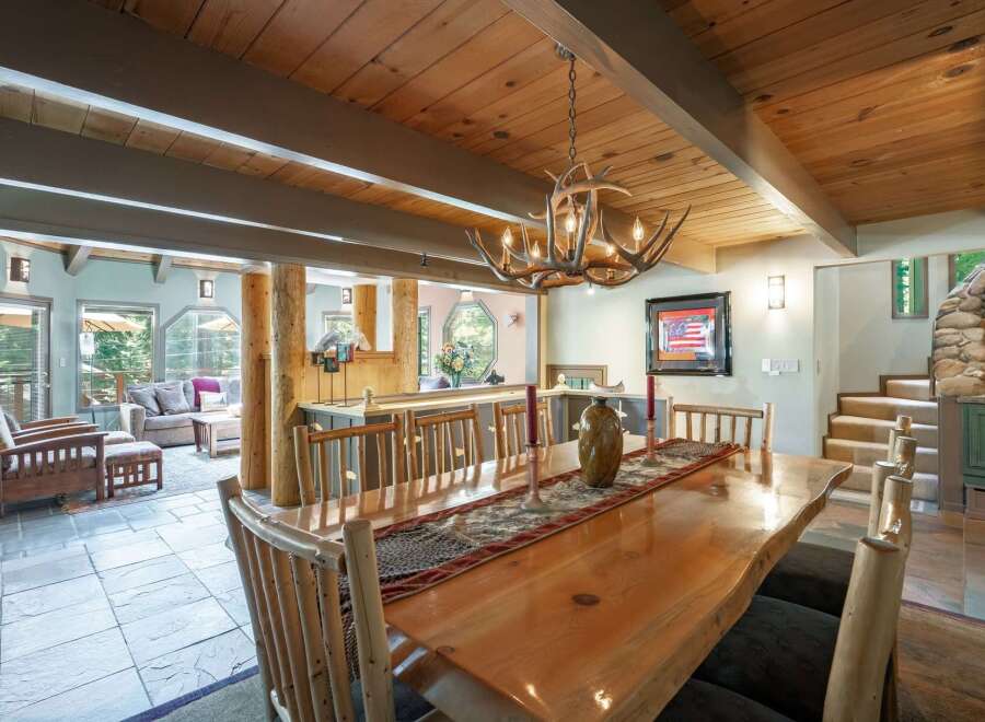 Experience rustic charm in this spacious dining area, featuring a live-edge wood table perfect for gatherings.