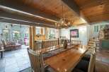Experience rustic charm in this spacious dining area, featuring a live-edge wood table perfect for gatherings.
