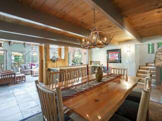 Experience rustic charm in this spacious dining area, featuring a live-edge wood table perfect for gatherings.