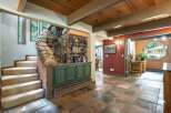 Discover rustic charm in this home featuring a stunning stone accent wall and a built-in bar area, perfect for entertaining.