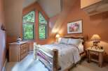 Experience rustic charm in this cozy bedroom, featuring a unique log bed and a charming quilt.