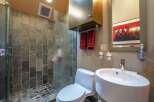 Experience modern luxury in this stylish bathroom, featuring a spacious walk-in shower with slate tile accents and a sleek glass enclosure.