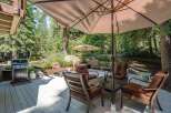 Enjoy outdoor living at its finest on this spacious deck, perfect for entertaining or relaxing amidst a serene wooded setting.