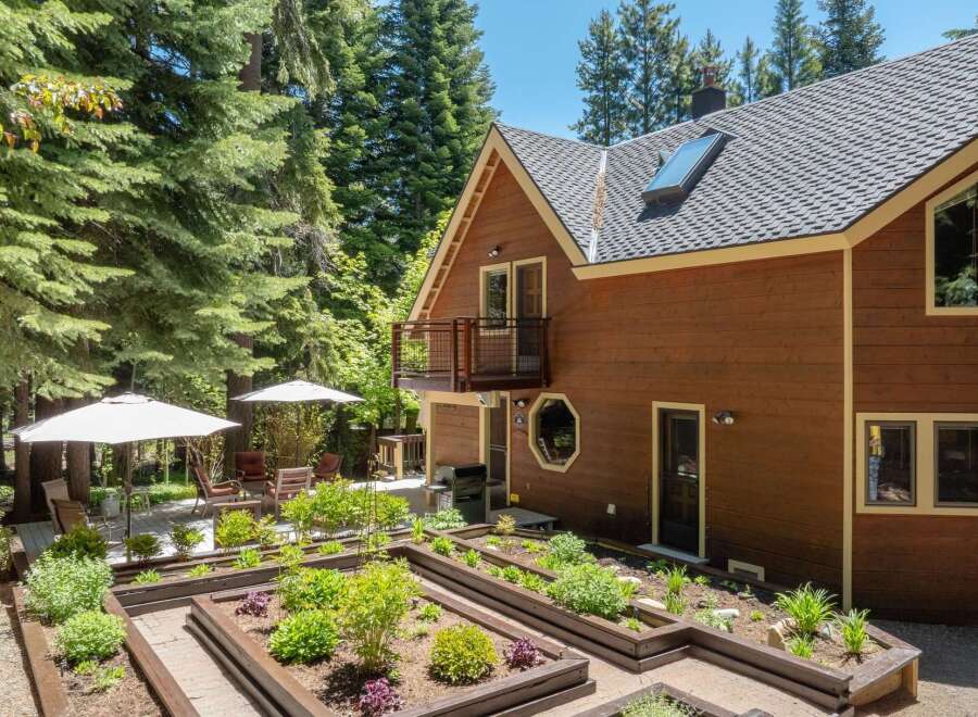 Discover this charming home featuring a beautifully maintained raised garden bed area, perfect for cultivating your own produce.