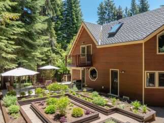Discover this charming home featuring a beautifully maintained raised garden bed area, perfect for cultivating your own produce.