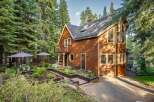 Nestled amidst towering pine trees, this charming wooden cabin offers a serene mountain retreat.