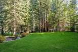 Enjoy the tranquility of this expansive backyard, featuring a lush, green lawn perfect for recreation and relaxation.