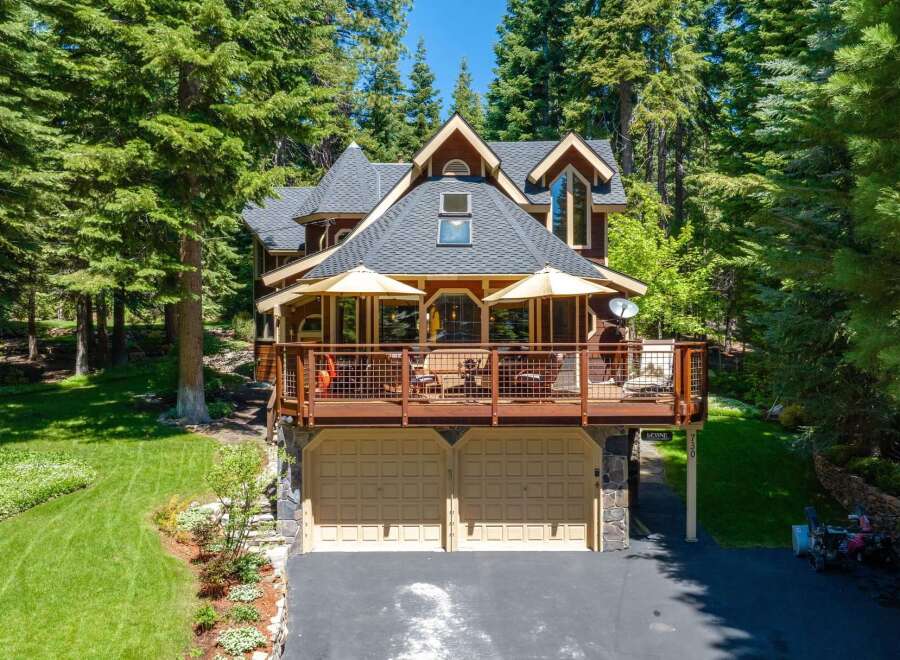 Nestled amidst towering pine trees, this stunning mountain home offers a perfect blend of rustic charm and modern comfort.