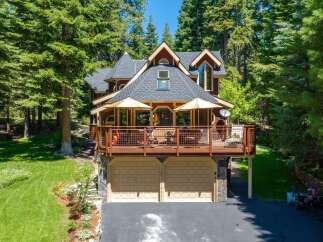 Nestled amidst towering pine trees, this stunning mountain home offers a perfect blend of rustic charm and modern comfort.