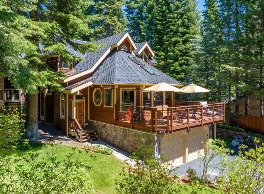 Nestled amidst towering pine trees, this charming wooden home offers a serene mountain retreat.