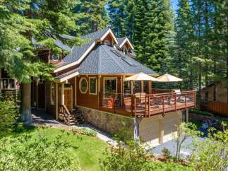 Nestled amidst towering pine trees, this charming wooden home offers a serene mountain retreat.