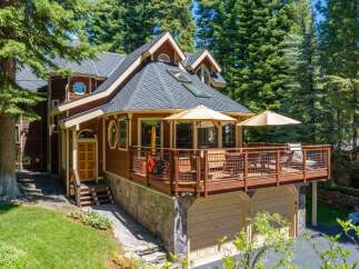 Nestled amidst towering pine trees, this charming mountain home offers a serene retreat.