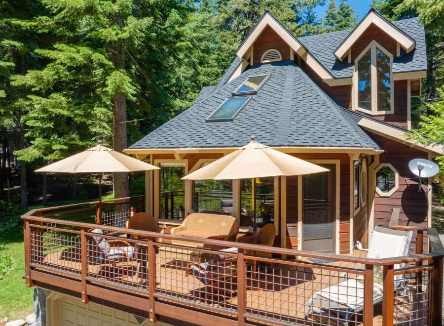 Enjoy outdoor living on this spacious deck, perfect for entertaining or relaxing amidst the trees.