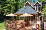 Enjoy outdoor living on this spacious deck, perfect for entertaining or relaxing amidst the trees.