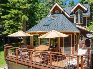 Enjoy outdoor living on this spacious deck, perfect for entertaining or relaxing amidst the trees.