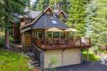Nestled amidst towering trees, this charming wooden home offers a serene mountain retreat.