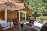 Enjoy outdoor living on this spacious wooden deck, perfect for entertaining or relaxing amidst the serene forest setting.