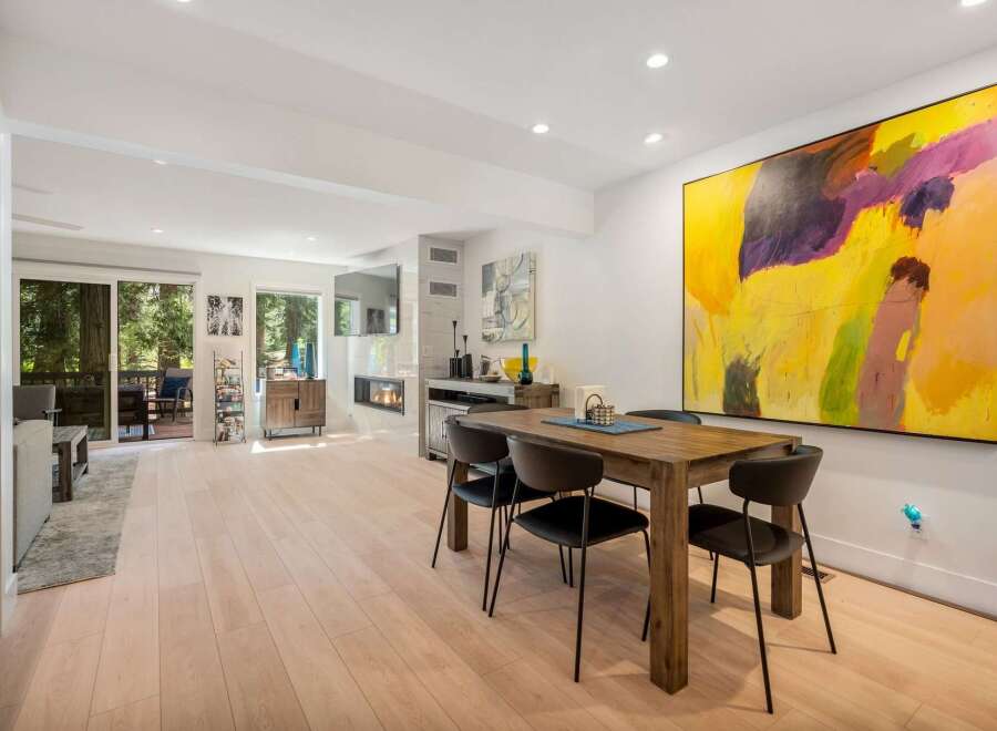 Experience modern living in this spacious open-concept home, featuring a sleek dining area perfect for gatherings and a cozy living space with a fireplace.